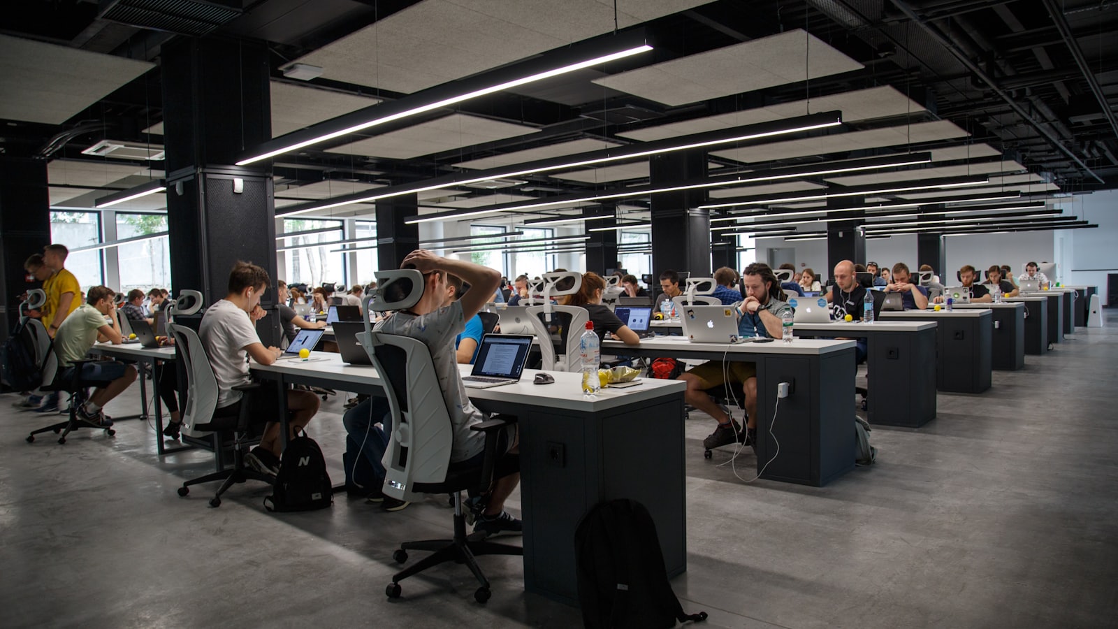 A wide view of an open-plan studio with people working at desks.